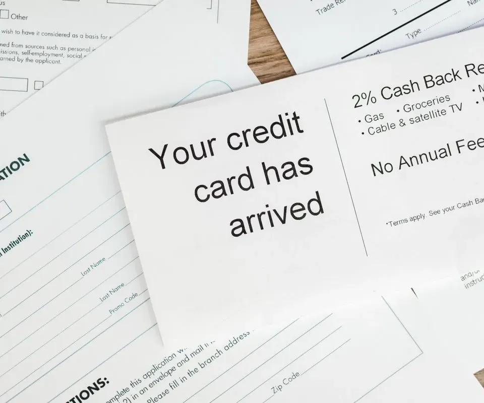 A credit card application form lying on loan paperwork