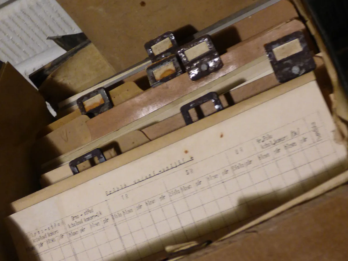 An open box of old file cards and folders