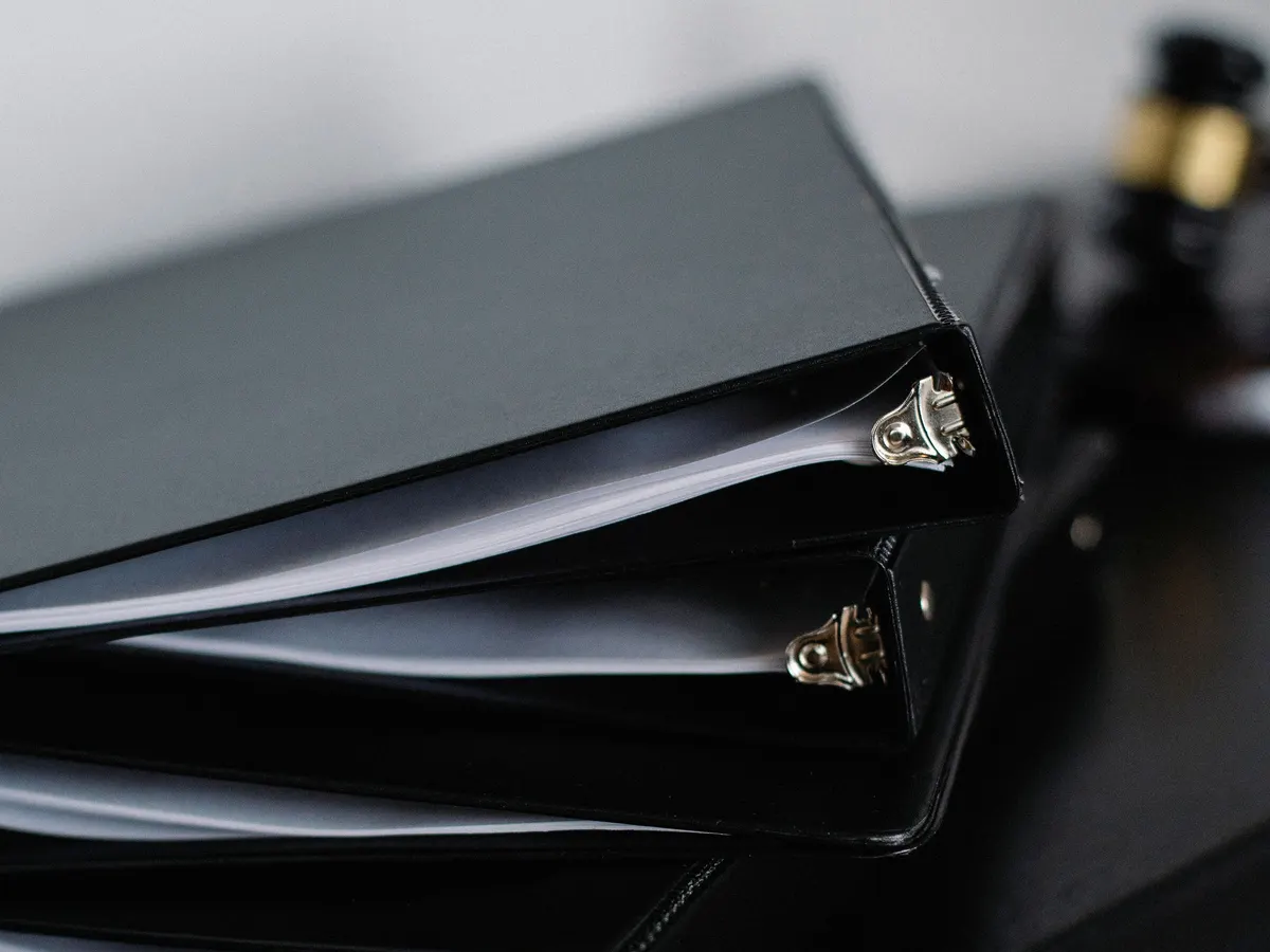 A stack of black ring binders