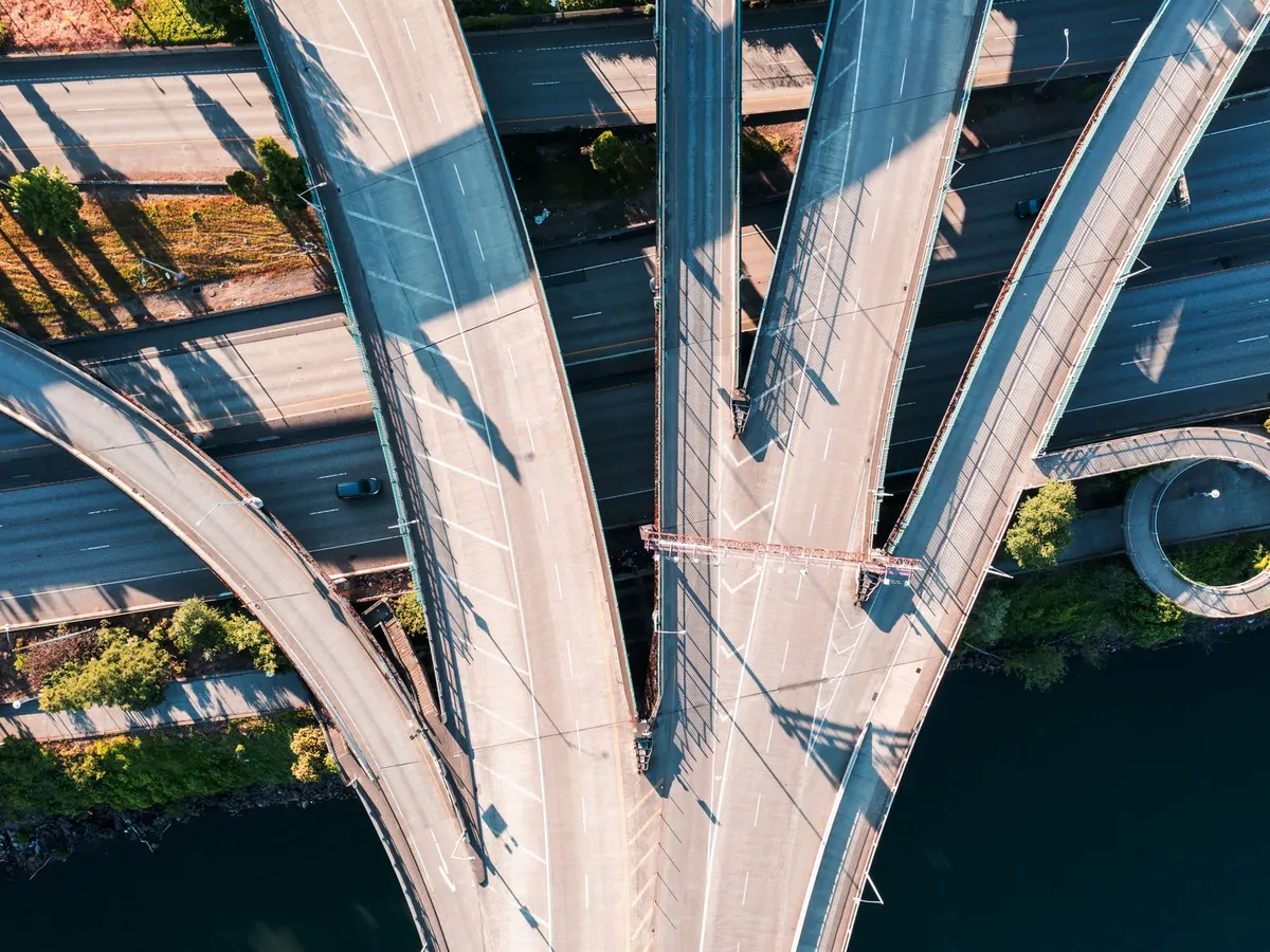 Aerial view of a road interchange whose ramps cross a river